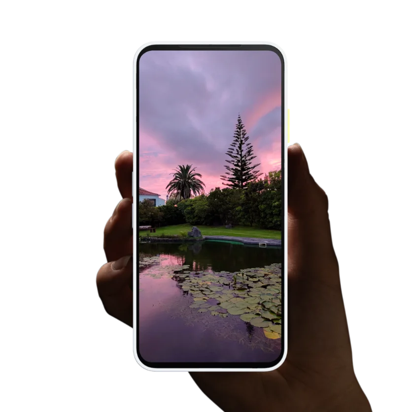 Hand holding a Fairphone Gen.6 displaying a sunset landscape, highlighting the OLED display's colors