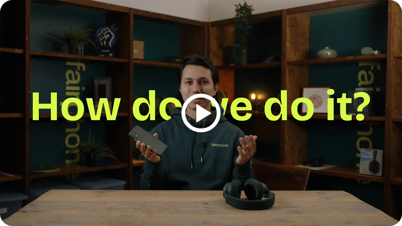 A young man sits in the middle of the Fairphone studio explaining how Fairphone makes sustainable tech.