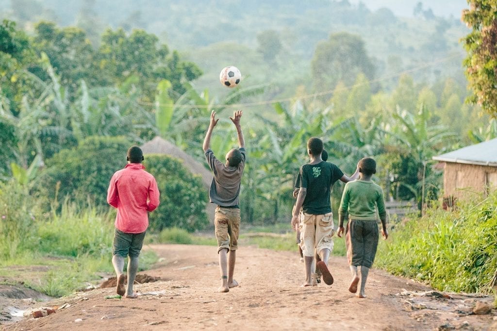 Photo of children playing on a dirt path