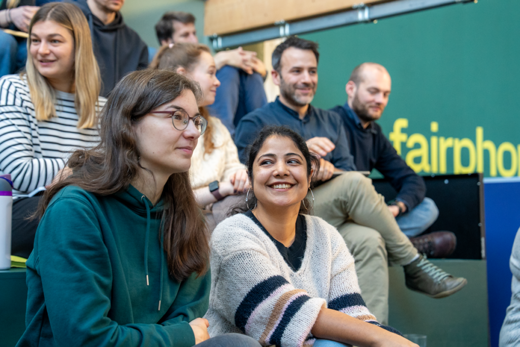 Diverse staffers of Fairphone sit with each other at the quarterly meeting.
